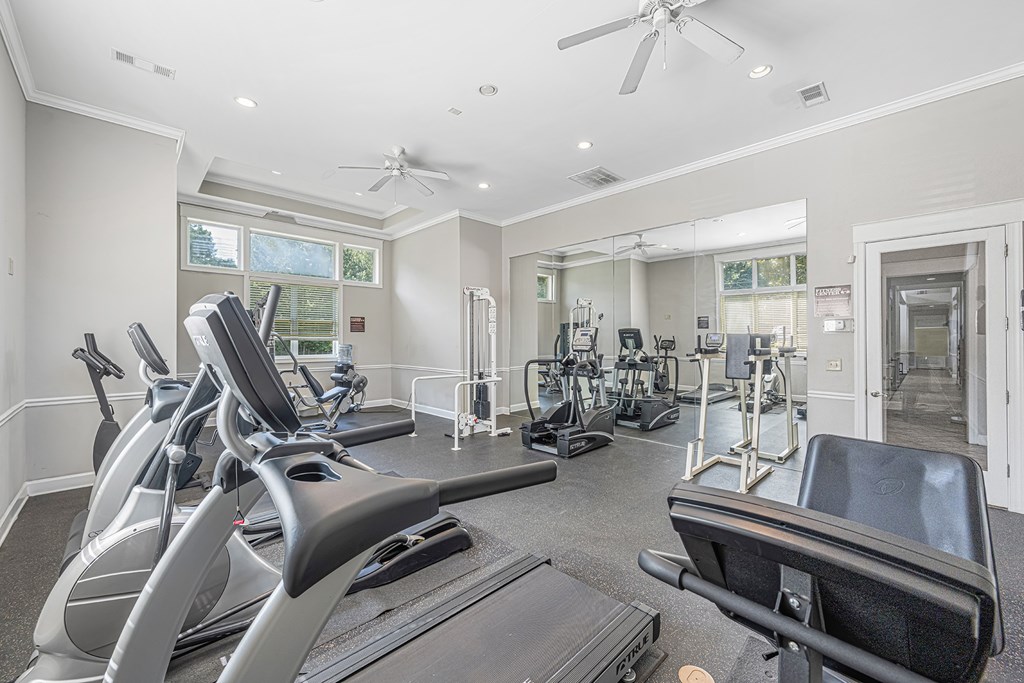 a gym with treadmills and other exercise equipment