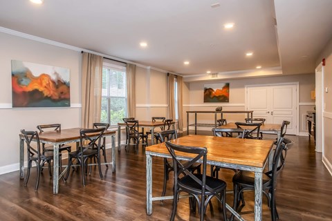 A dining room with a wooden table and chairs.
