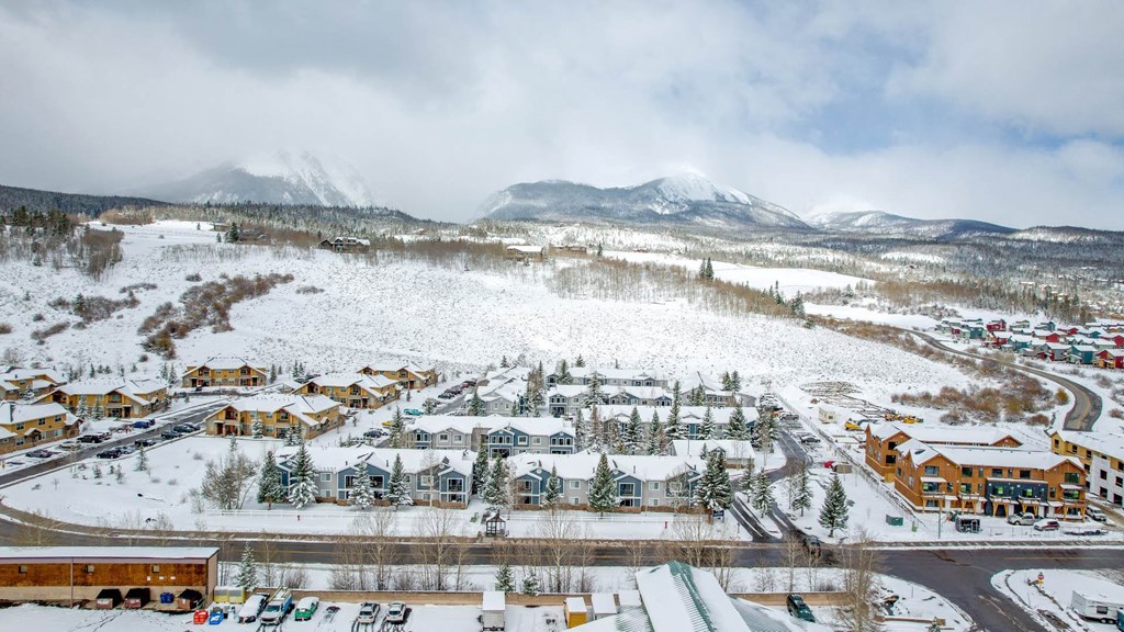 a city covered in snow with mountains in the background