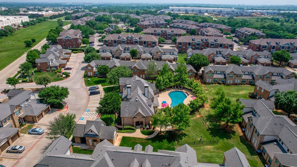 an aerial view of a neighborhood with houses and a swimming pool