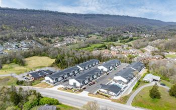 a aerial view of a group of houses and a city