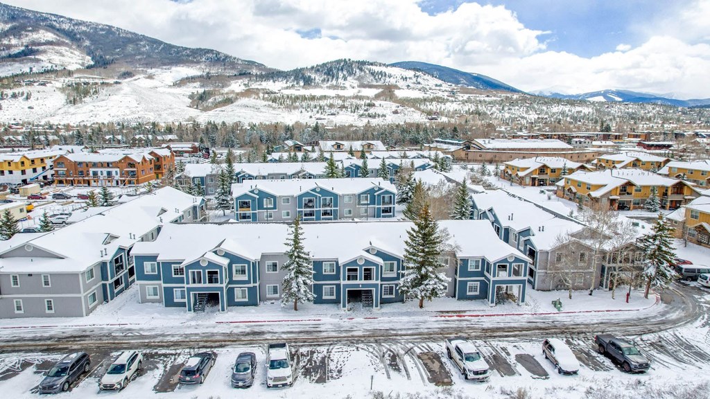 a city covered in snow with a mountain in the background