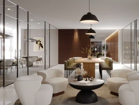 A modern dining room with a round table and white chairs.