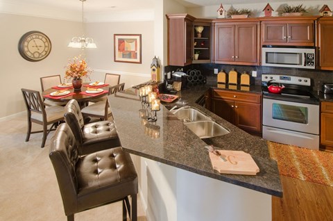 a kitchen and dining room with a granite counter top