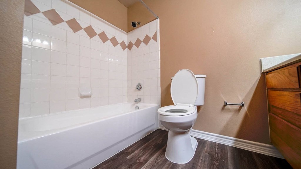 a bathroom with a toilet and a tub