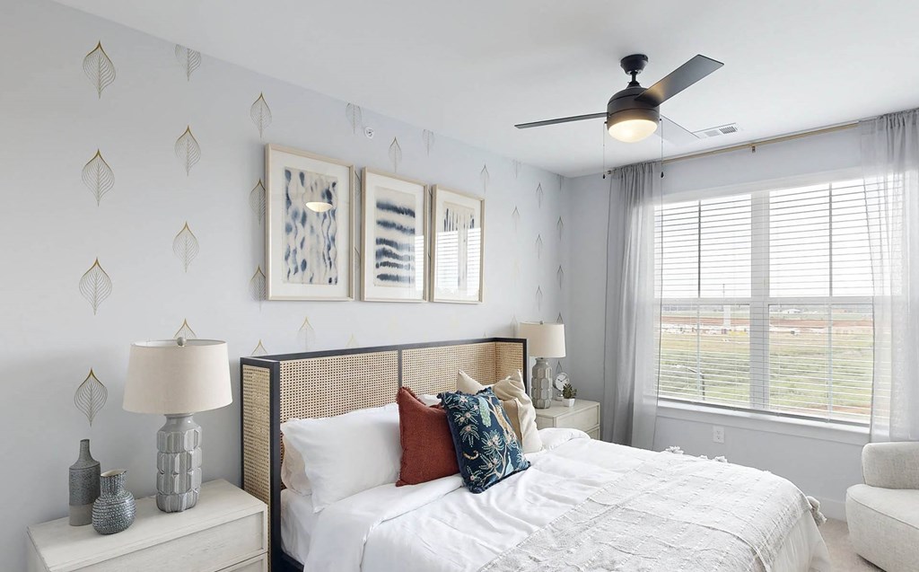 a bedroom with a large bed and a window