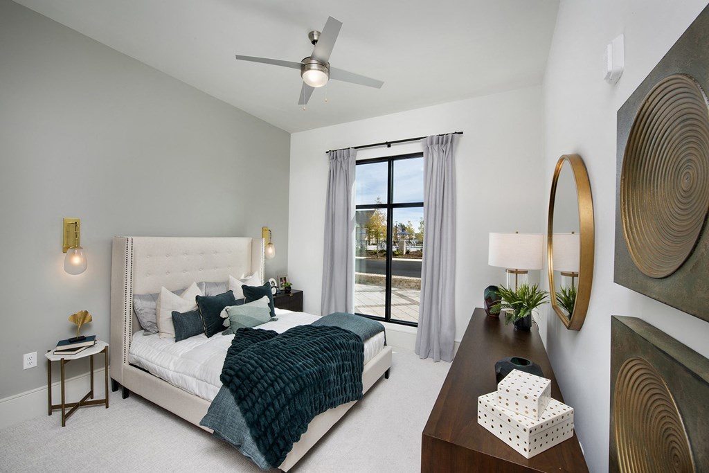 a bedroom with a bed and a ceiling fan