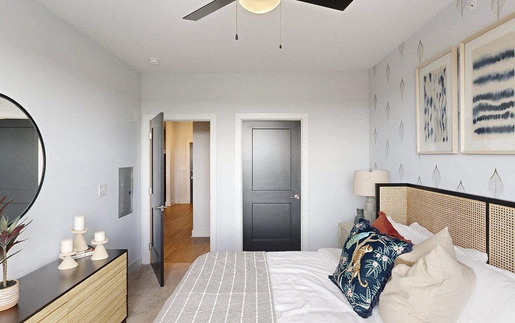 a bedroom with a bed and a ceiling fan