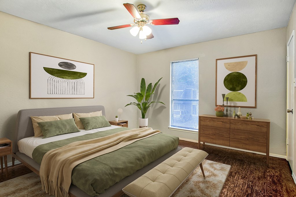 a bedroom with a large bed and a ceiling fan