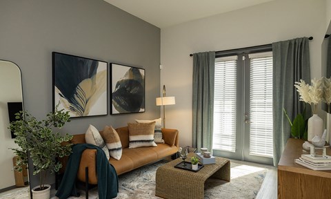 a living room with a brown leather couch and a table