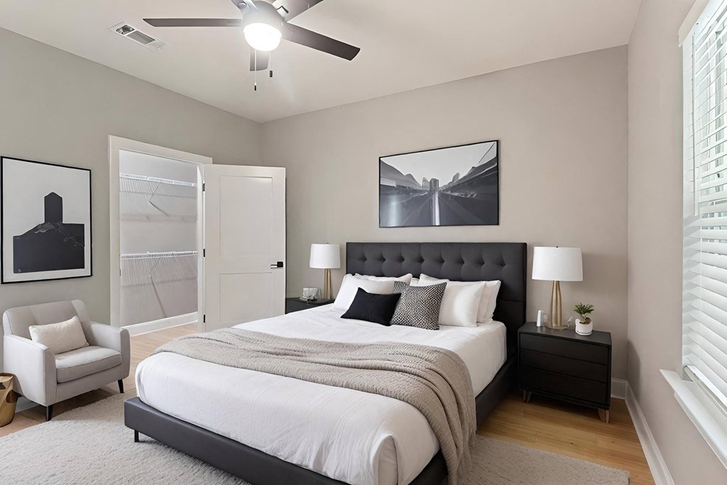 a bedroom with a bed and a ceiling fan