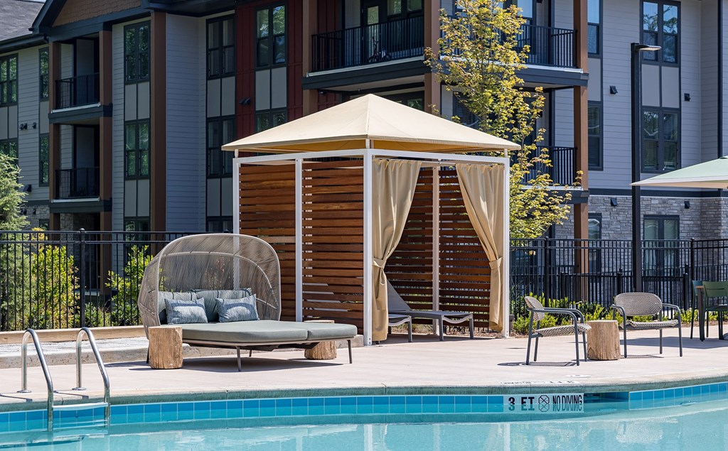 a gazebo with a canopy next to a swimming pool