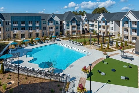 an aerial view of an apartment complex with a swimming pool