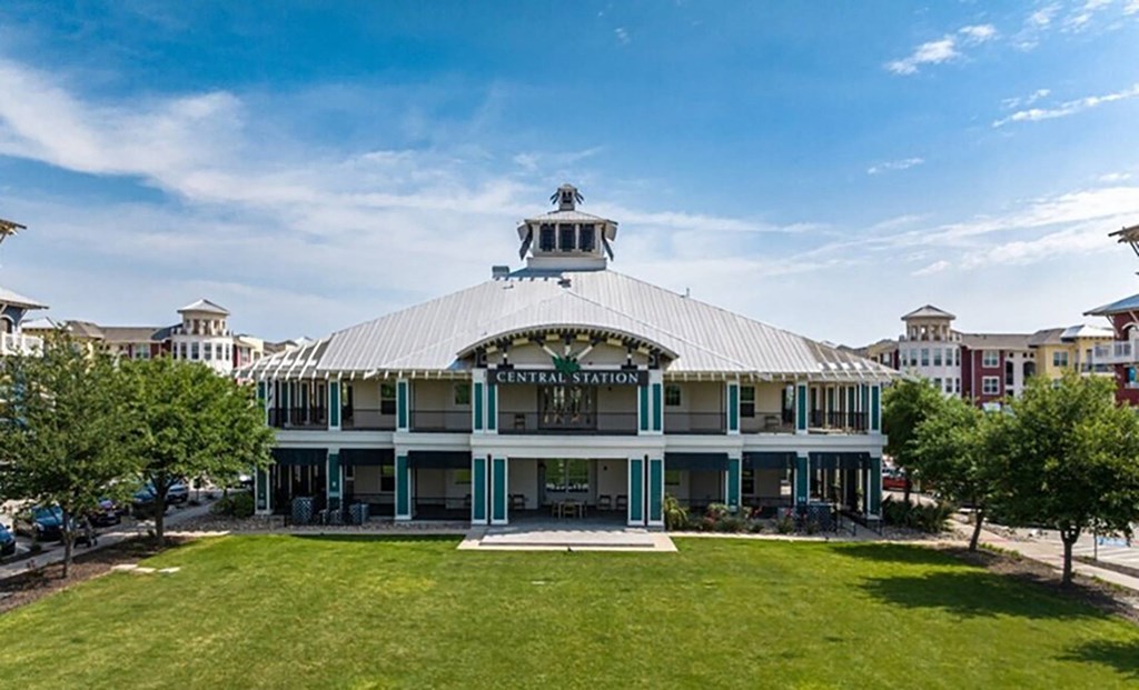 a building with a lawn and trees in front of it