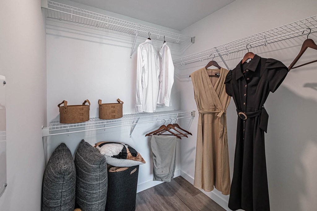a walk in closet filled with clothes and baskets at Altis Blue Lake, Lake Worth, FL