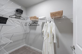 our spacious closets feature a spacious walk in closet with wire shelves and a spacious