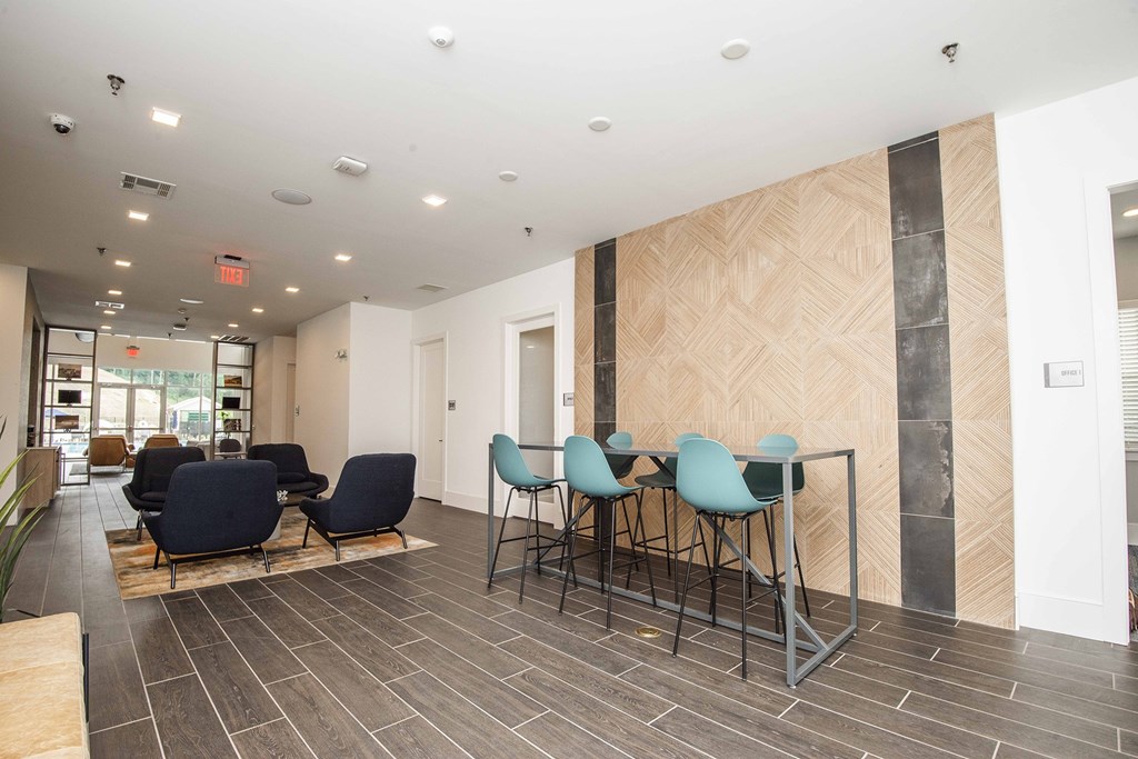 A waiting room with chairs and a table.