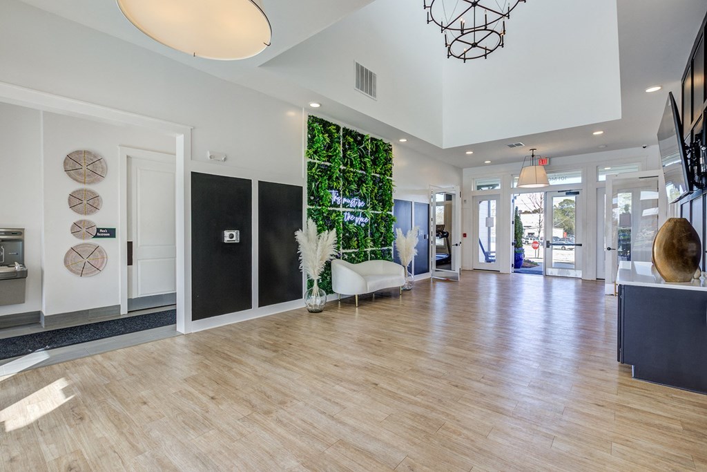 a living wall in the center of a room with a wooden floor