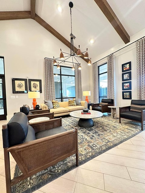 a living room with couches and chairs and a chandelier
