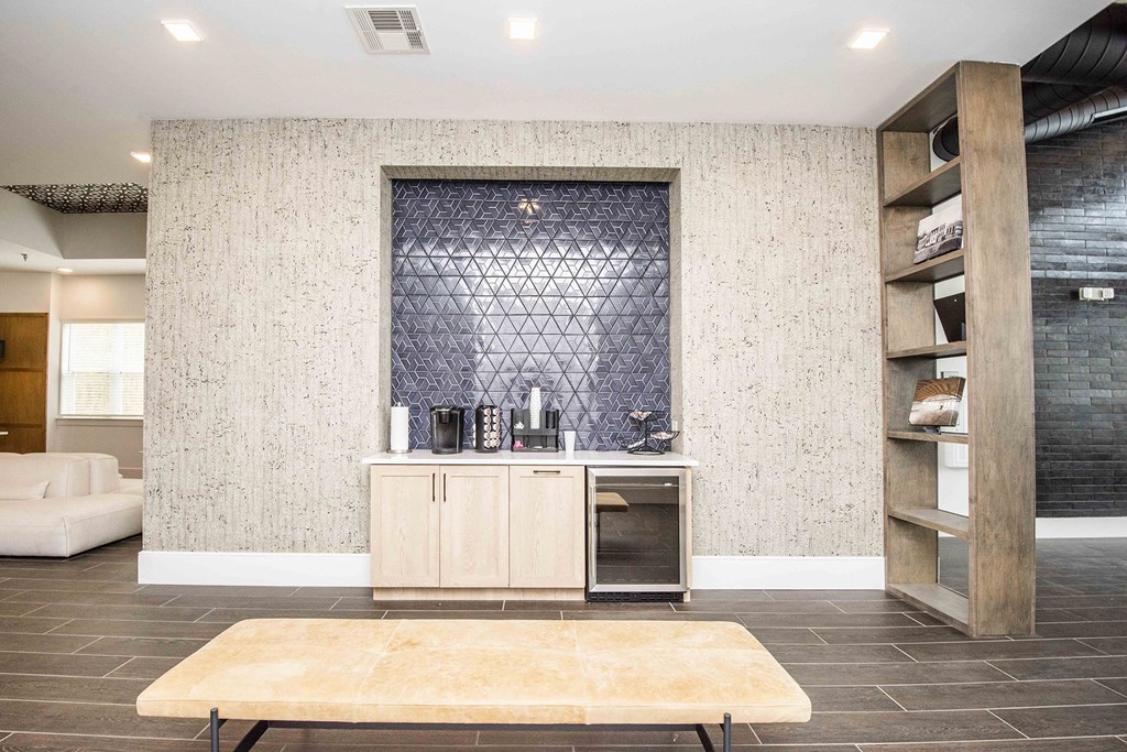 A kitchen area with a wooden table and a wall with a textured pattern.