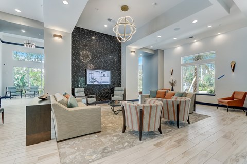 A modern living room with a large sofa set and a television.