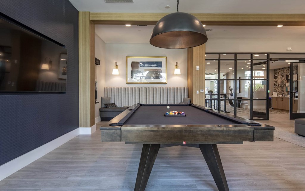 a billiards table in the clubhouse of a house