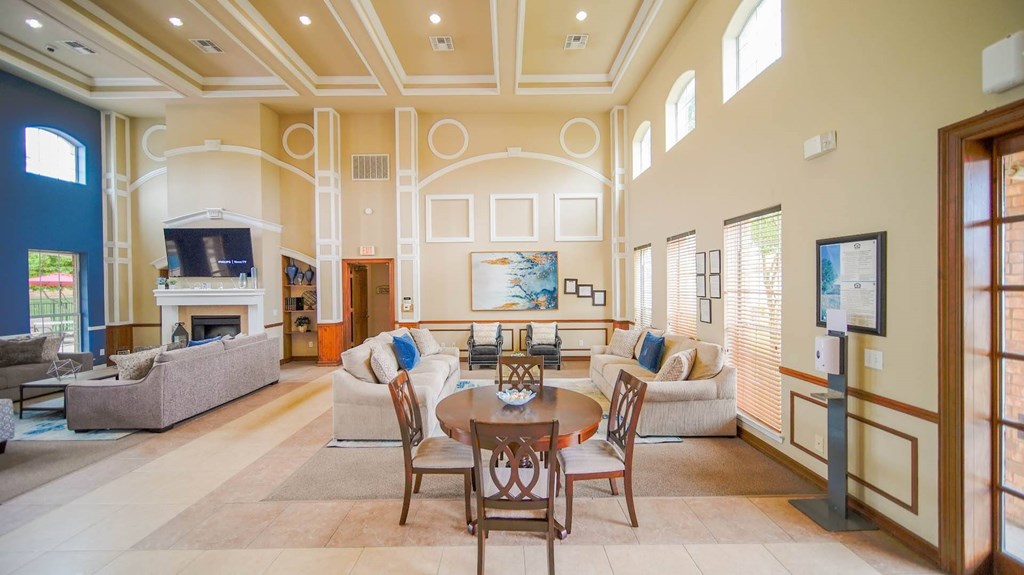 a large living room with couches and chairs and a table