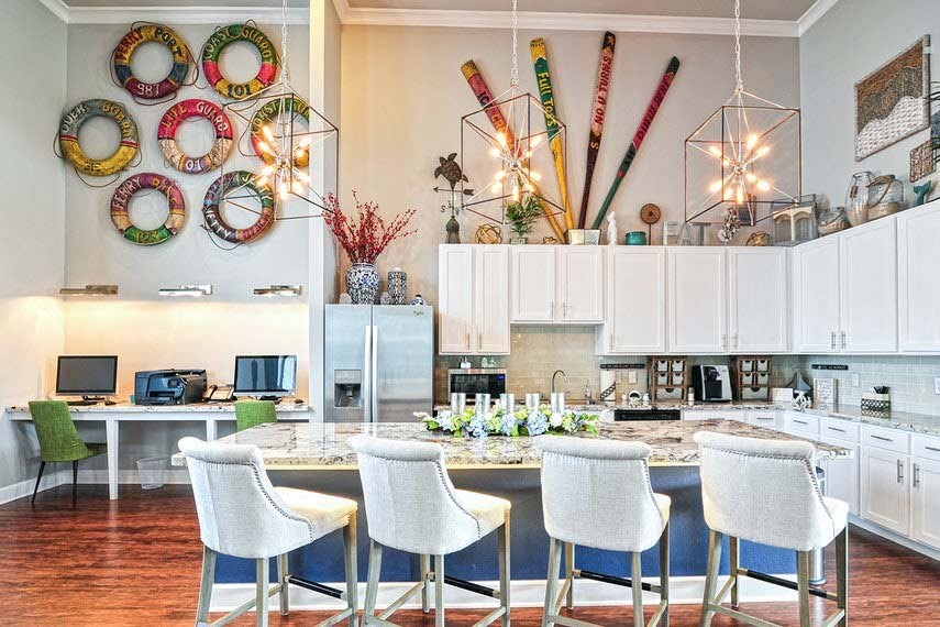 a kitchen with white cabinets and a table with chairs