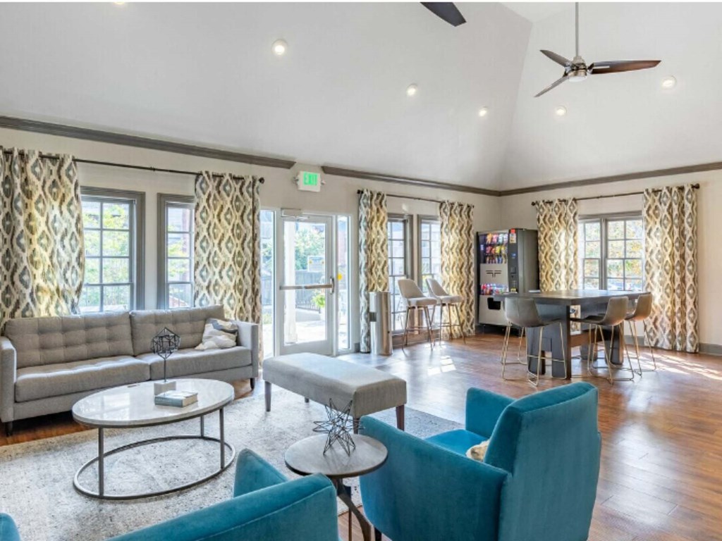 a living room with couches and chairs and a piano