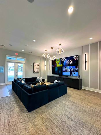 a large living room with couches and a tv