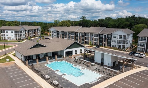 A large building complex with a pool in the foreground.
