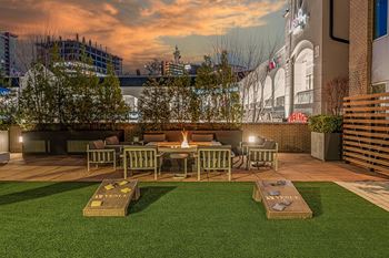 a rendering of a patio with grass and tables and chairs