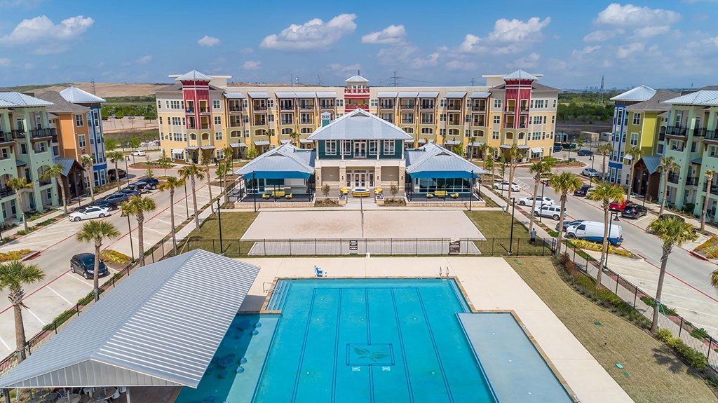 ewisville Apartments for Rent - Hebron 121 Station - Resort Style Pool with Lounge Seating, Clubhouse, and Volleyball Court