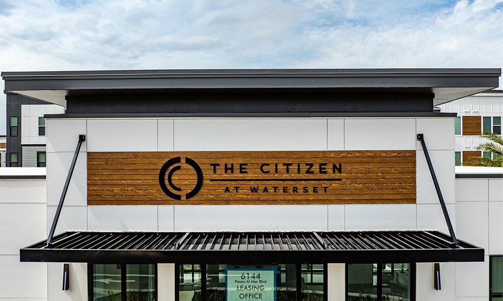 Logo of 'The Citizen at Waterset' displayed on the front of an apartment building in Florida.