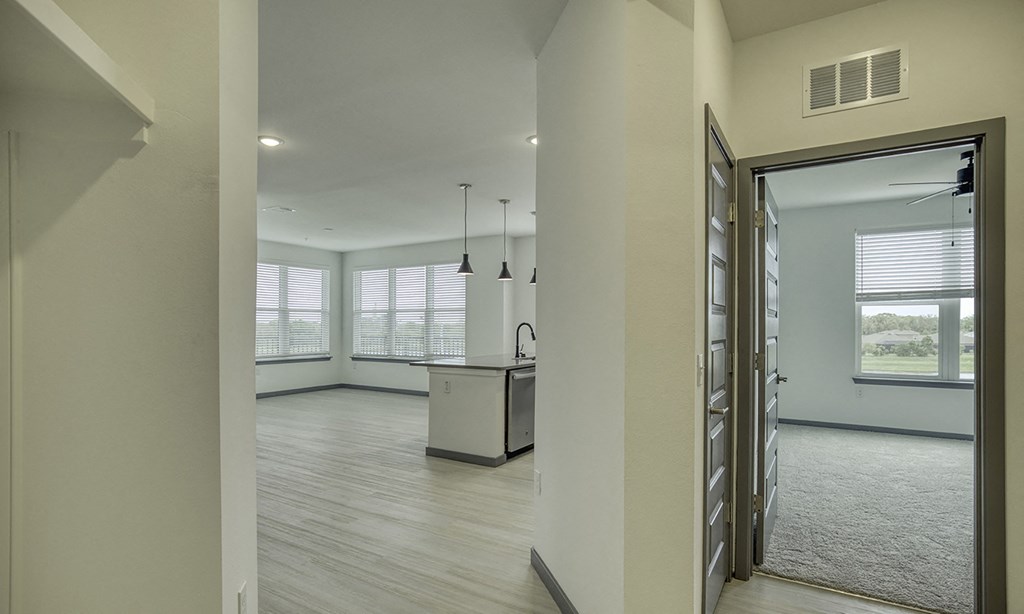 an open kitchen and living room with a large window