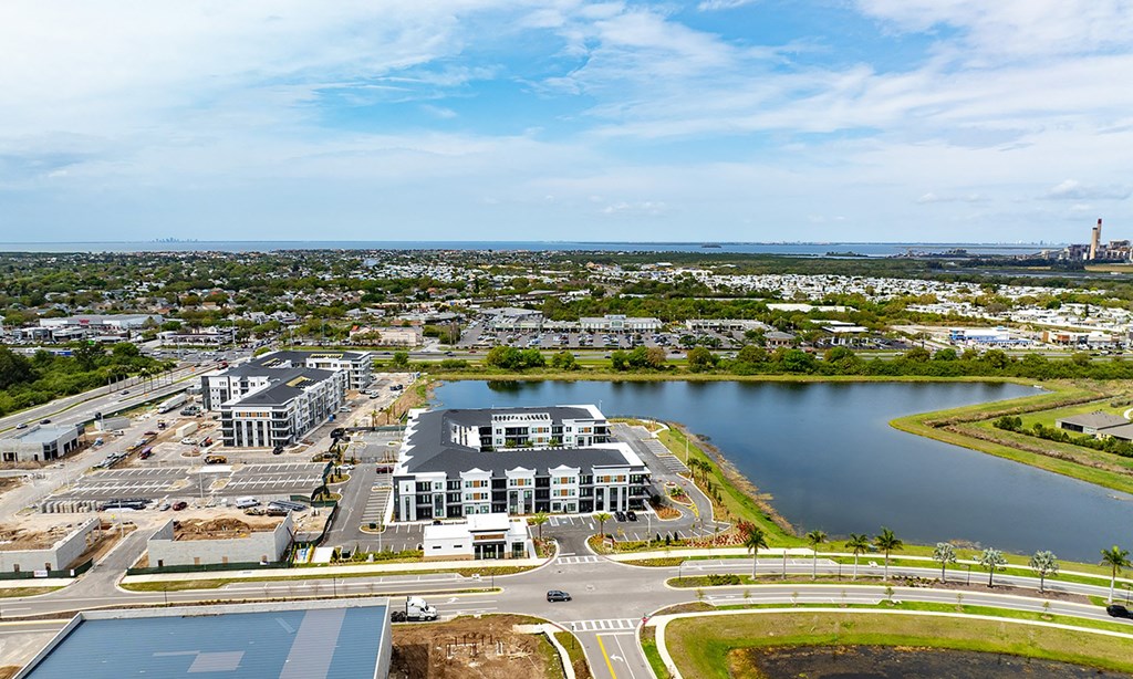 an aerial view of a city with a lake and buildings in apollo beach, florida