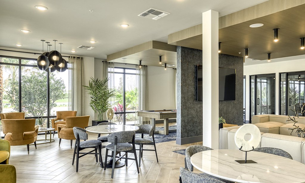 a lobby with a table and chairs and a couch