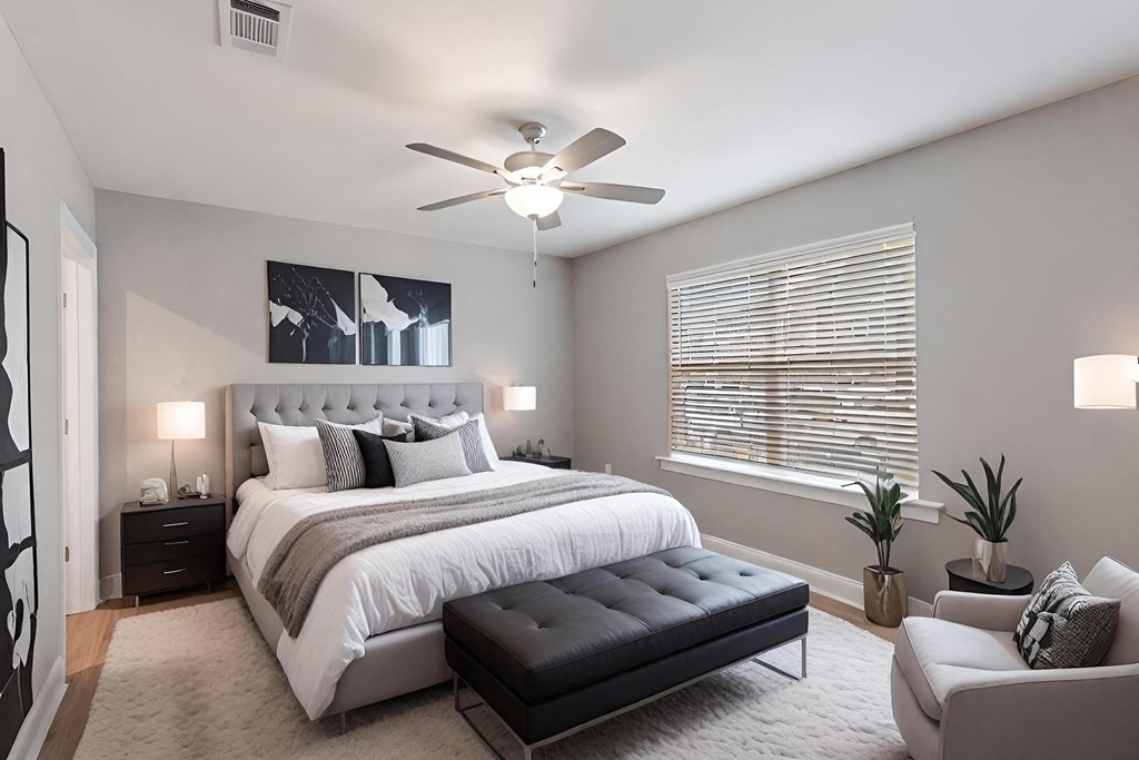 a bedroom with a bed and a ceiling fan