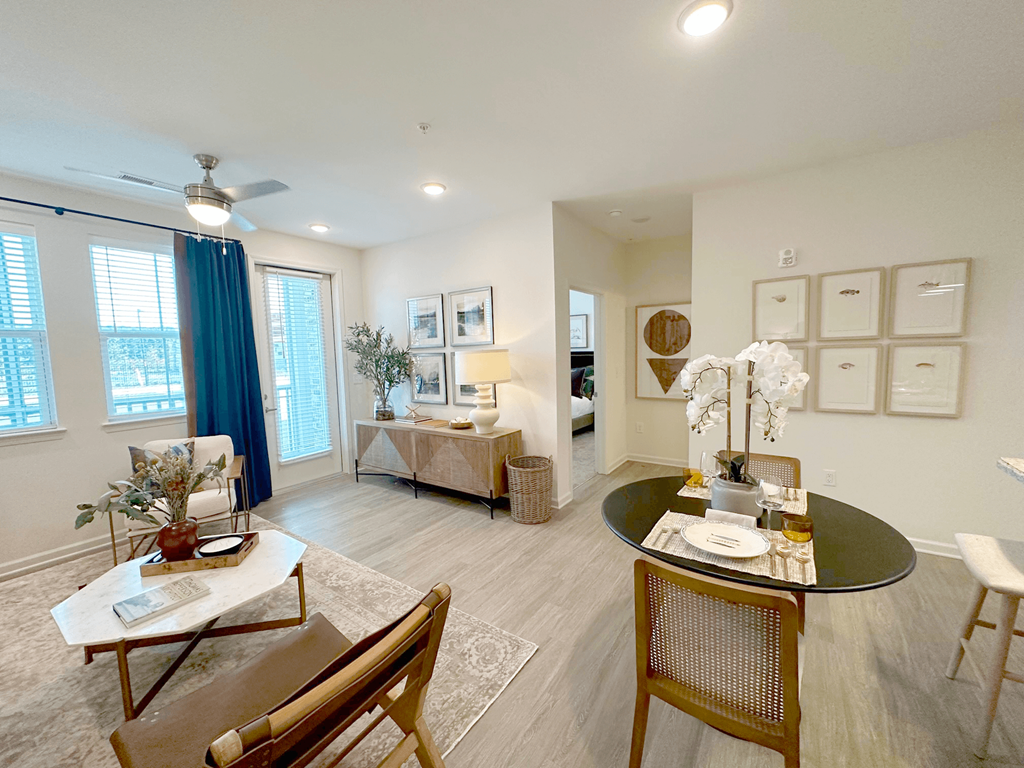 A living room with a dining table and chairs.