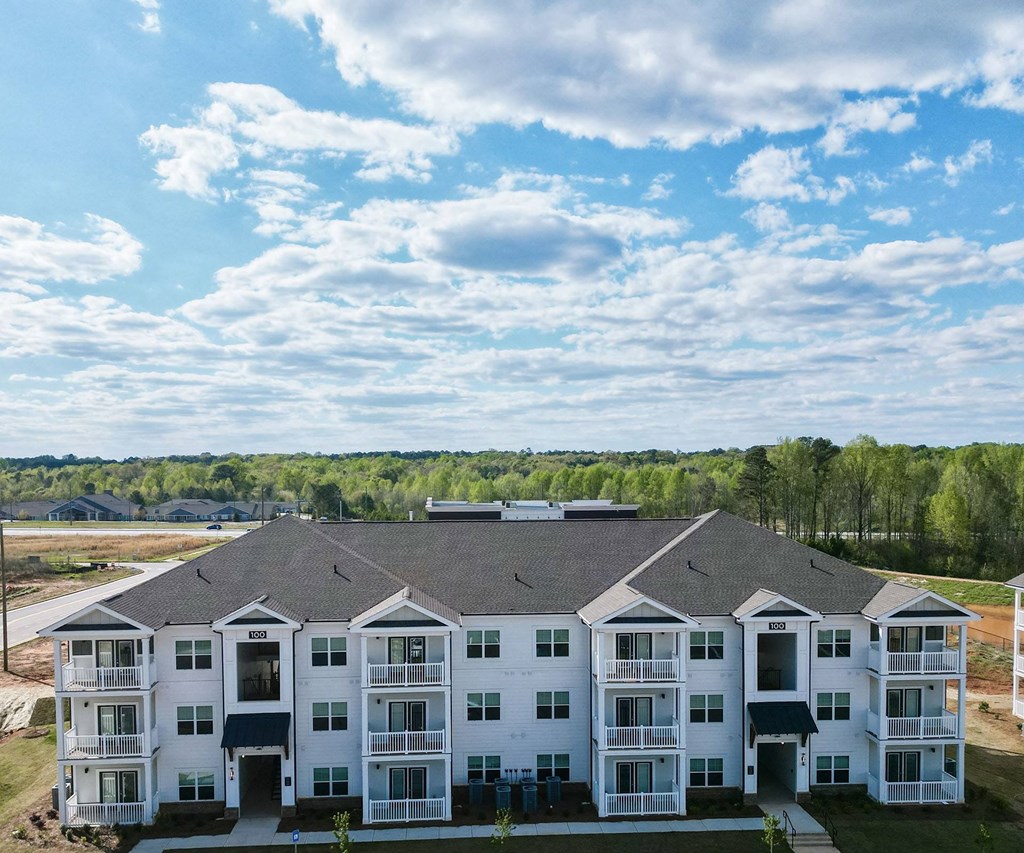 aerial view of an apartment building with a cloudy sky