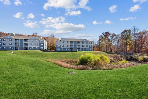 A grassy field with a building in the background.