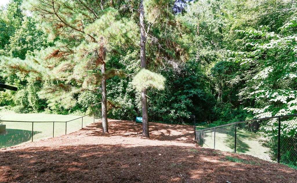 a park with trees and a tennis court