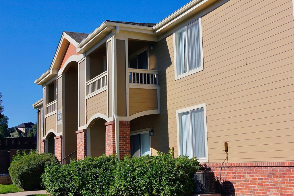 A two-story building with a balcony on the second floor.