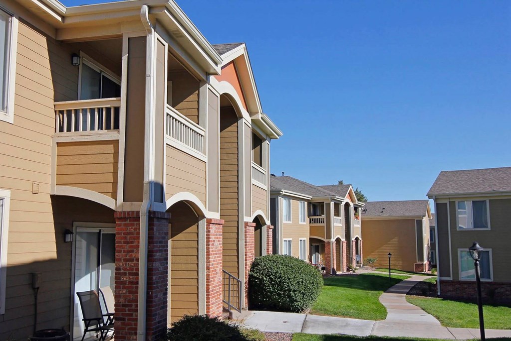 A row of houses with a clear blue sky above them.
