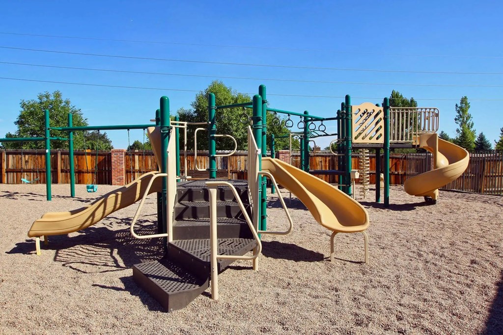 A playground with a slide, swings, and a climbing frame.