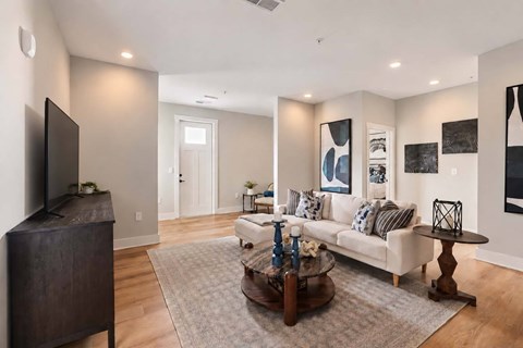 A living room with a white couch and a coffee table.