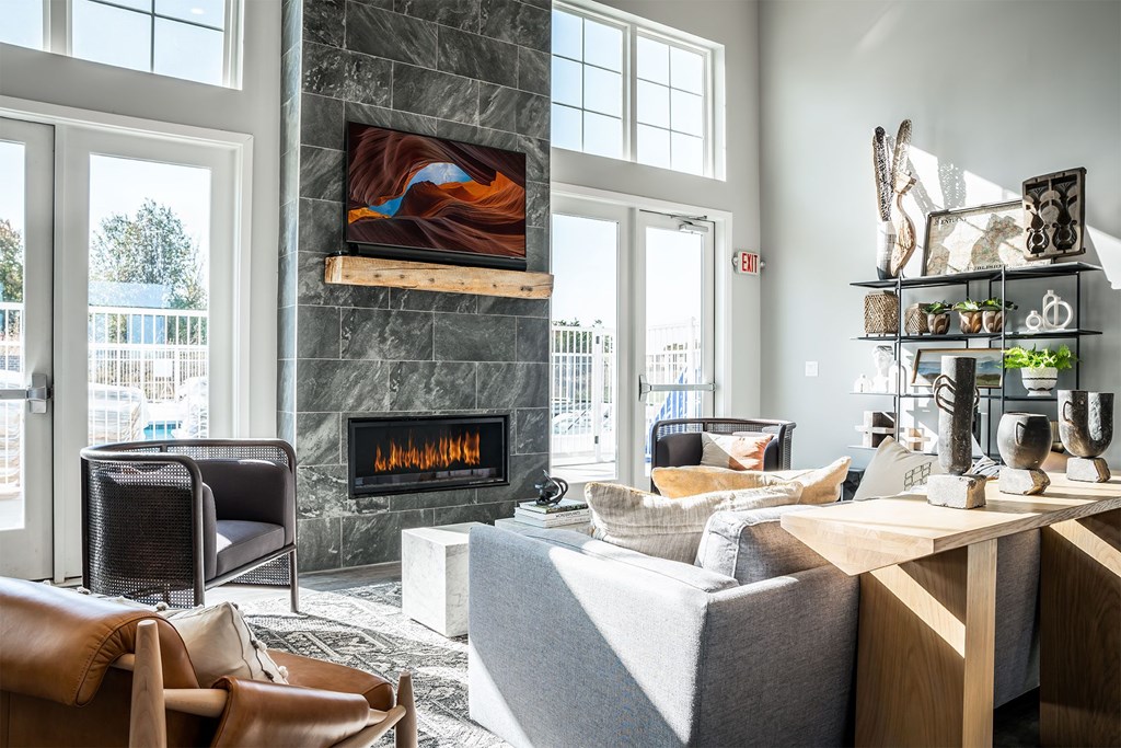 A living room with a fireplace and a painting on the wall.