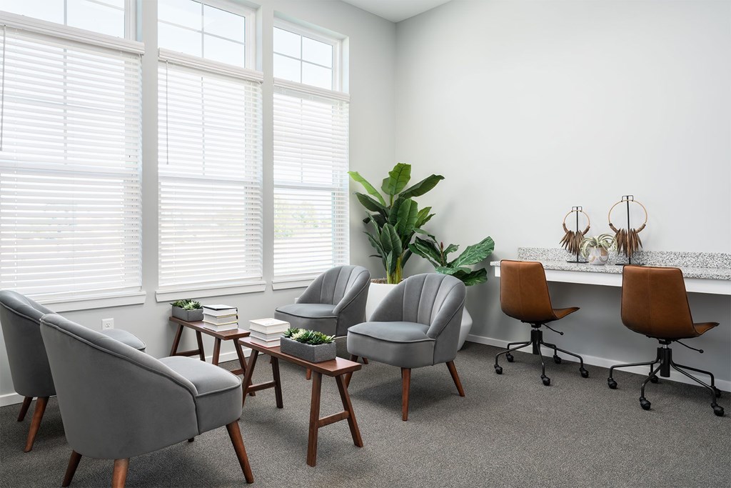 A room with a grey chair and a brown chair.