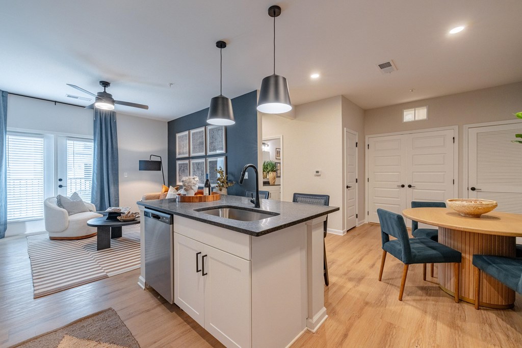 A modern kitchen with a dining table and chairs.