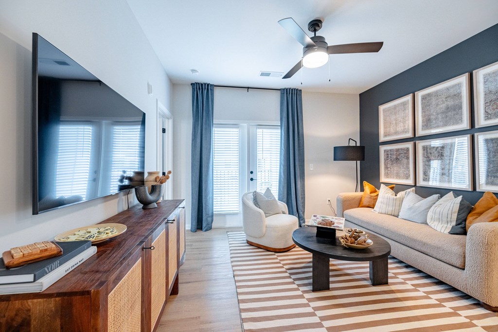 A modern living room with a striped rug and a white sofa.